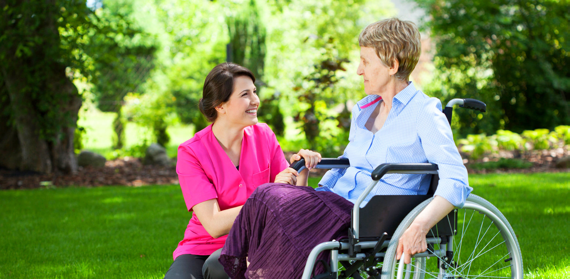 nurse and elderly woman in wheel chair